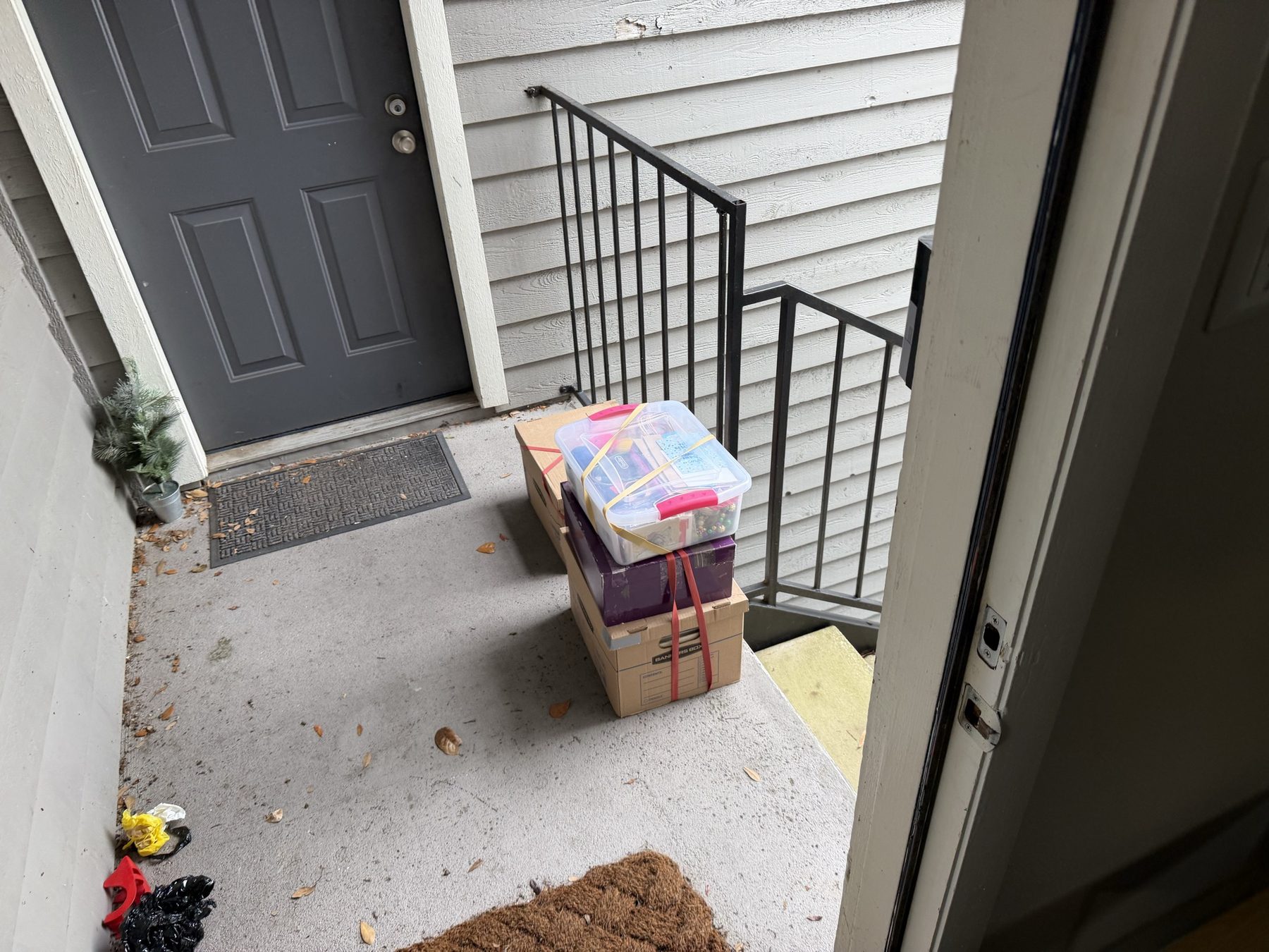 Moving boxes staged neatly on a front porch
