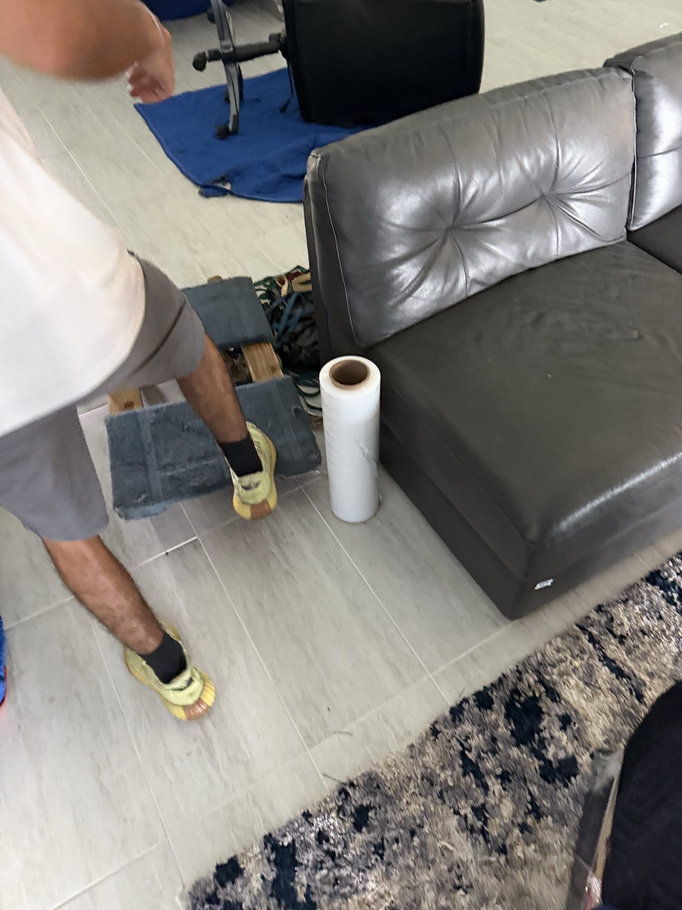 Tailwind Movers crew using a furniture slider on a job