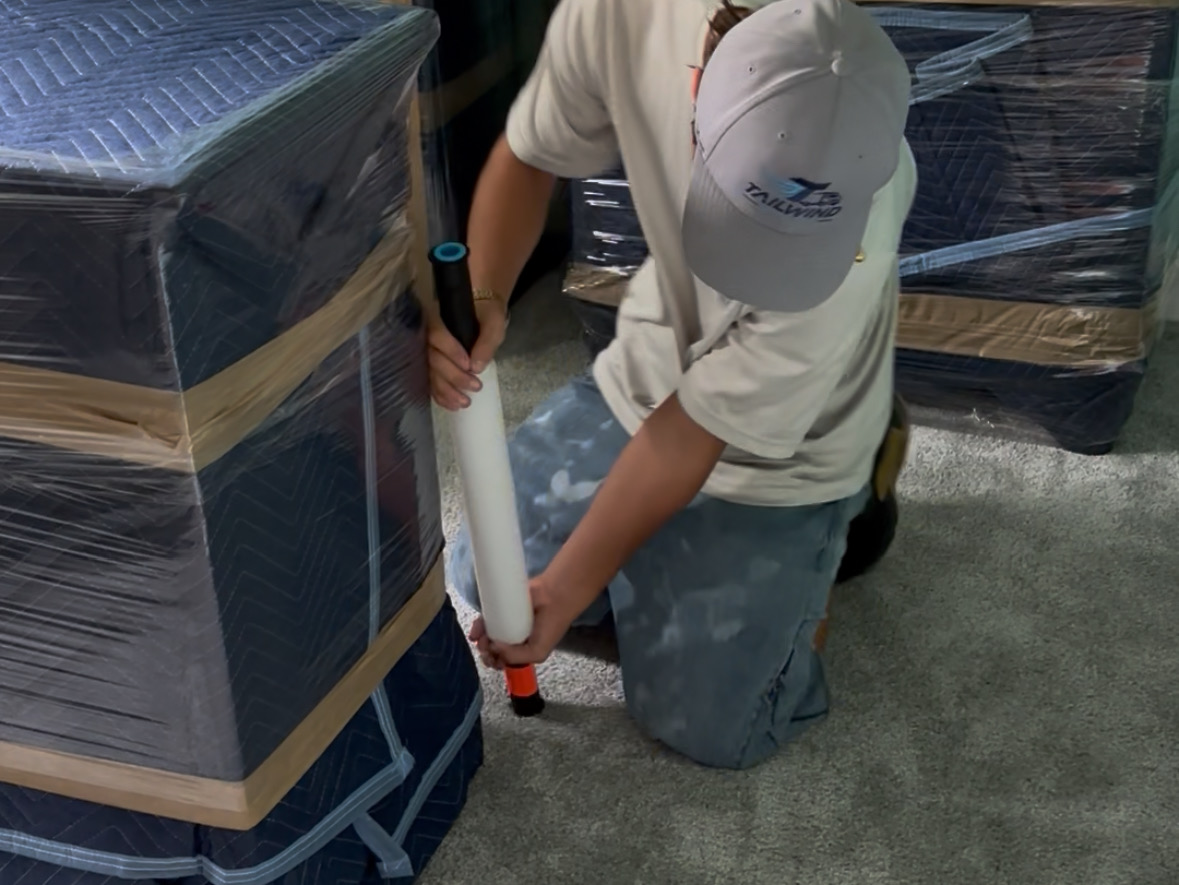 Tailwind Movers crew wrapping furniture on a job