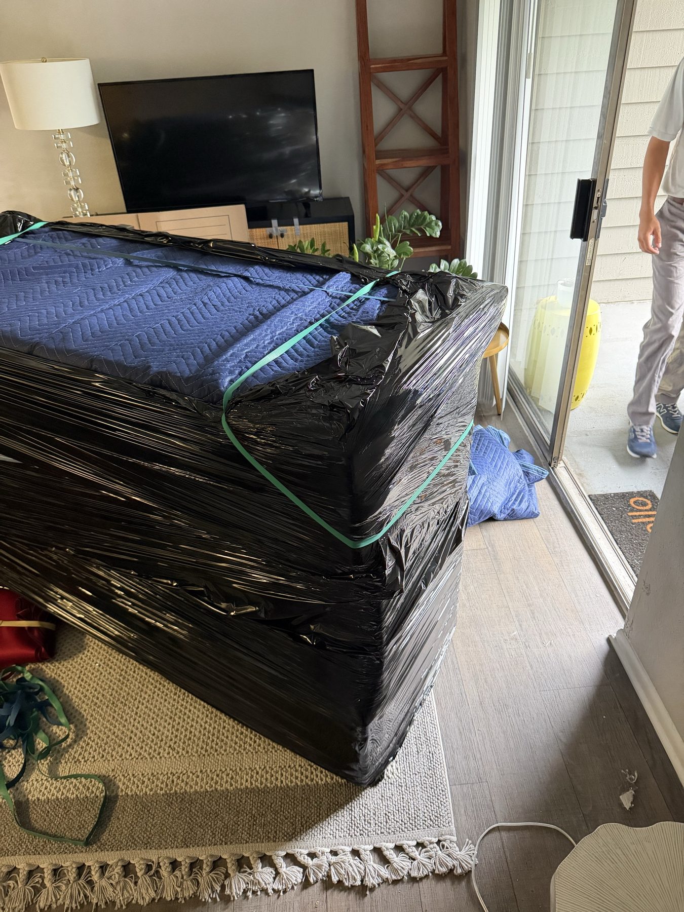 A mattress wrapped and secured for transport
