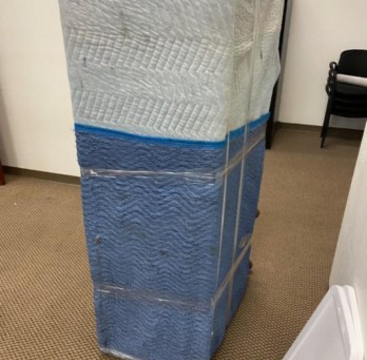An office file cabinet wrapped and ready for a commercial move