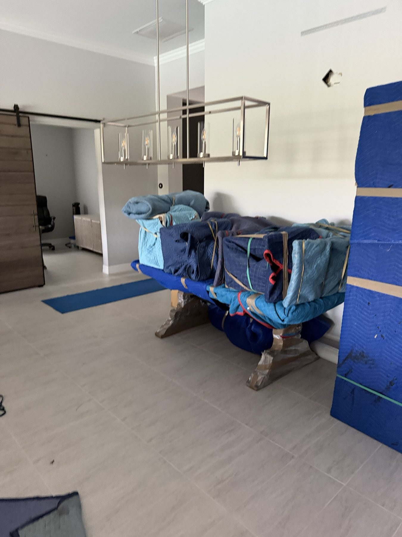 A table wrapped in moving pads and secured with straps