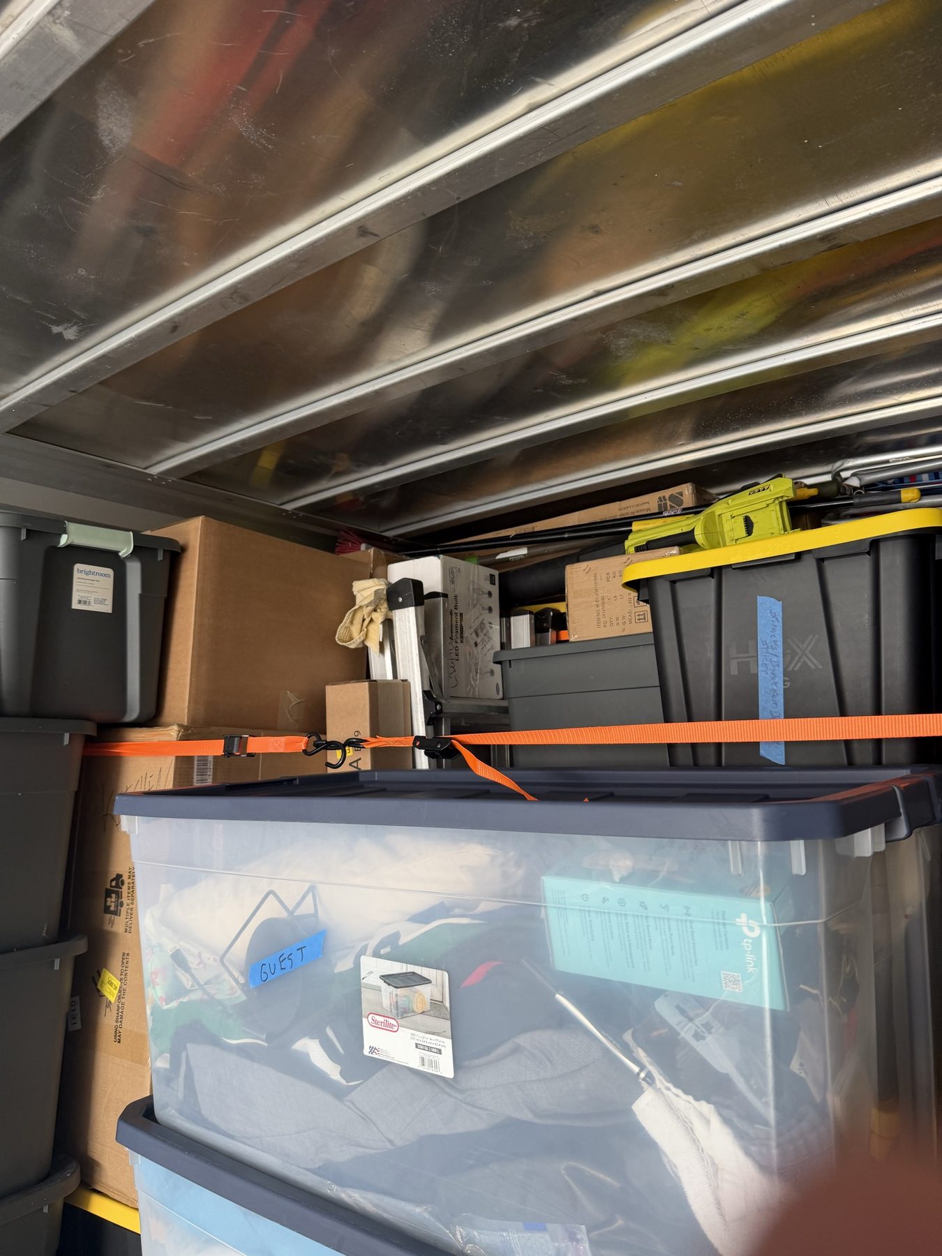Bins and boxes organized and strapped inside the Tailwind Movers truck